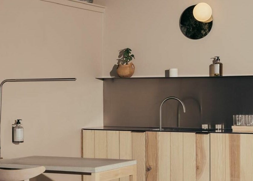 Minimalistic workspace at Buff Concept Store, Edinburgh, Scotland, GB with wooden shelves and modern lighting.