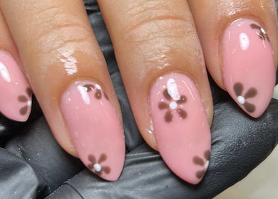 Beautiful floral nail art by Nails By Donna in Cannock, England, GB, featuring pink polish with delicate flower designs.