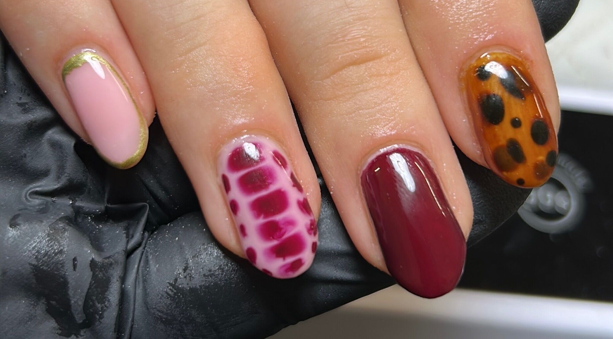 Diverse nail art at Nails By Donna in Cannock, England, GB with leopard and abstract designs.