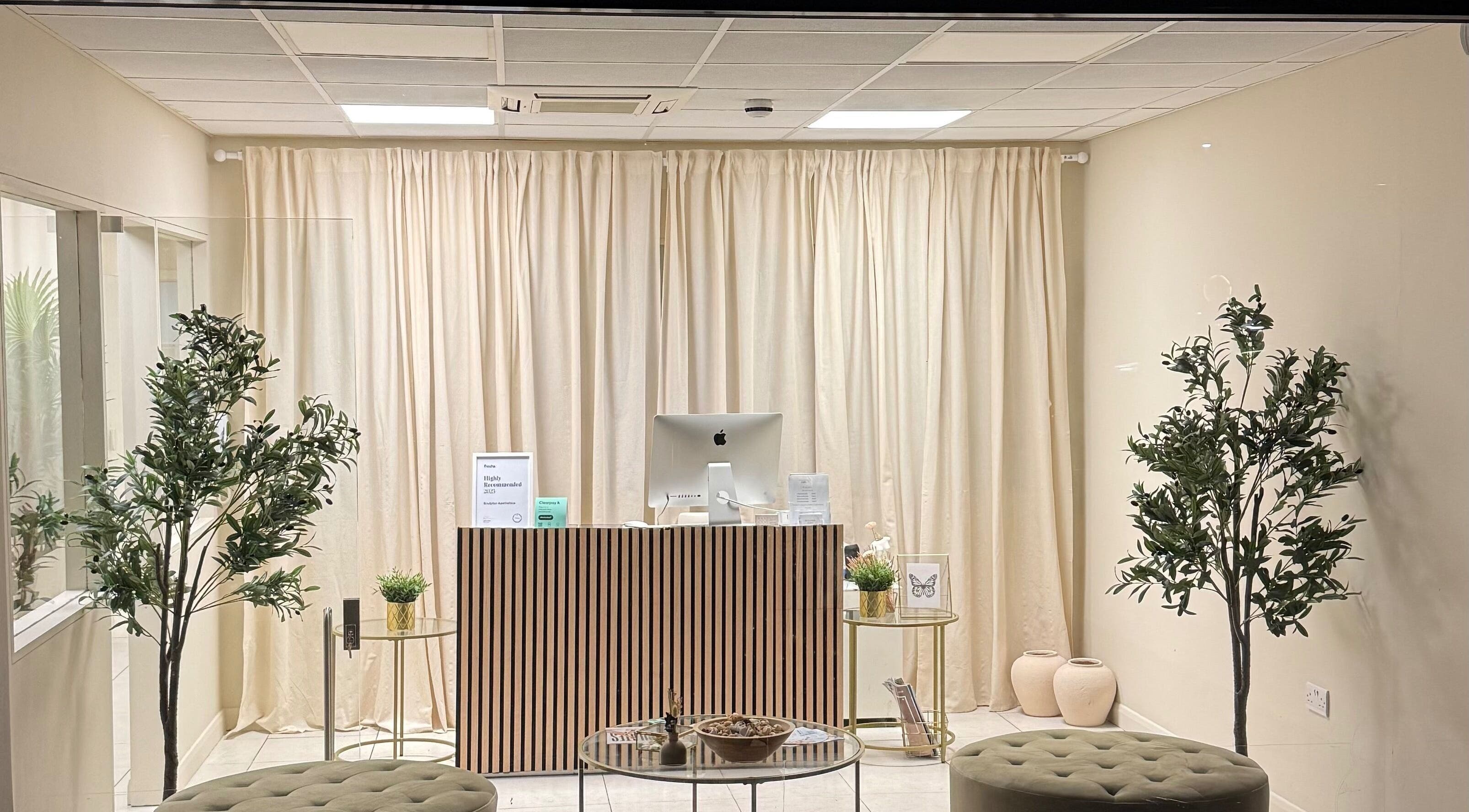 Elegant reception area at Sculptor Aesthetics, Edgware, England, GB with modern décor and soothing ambiance.