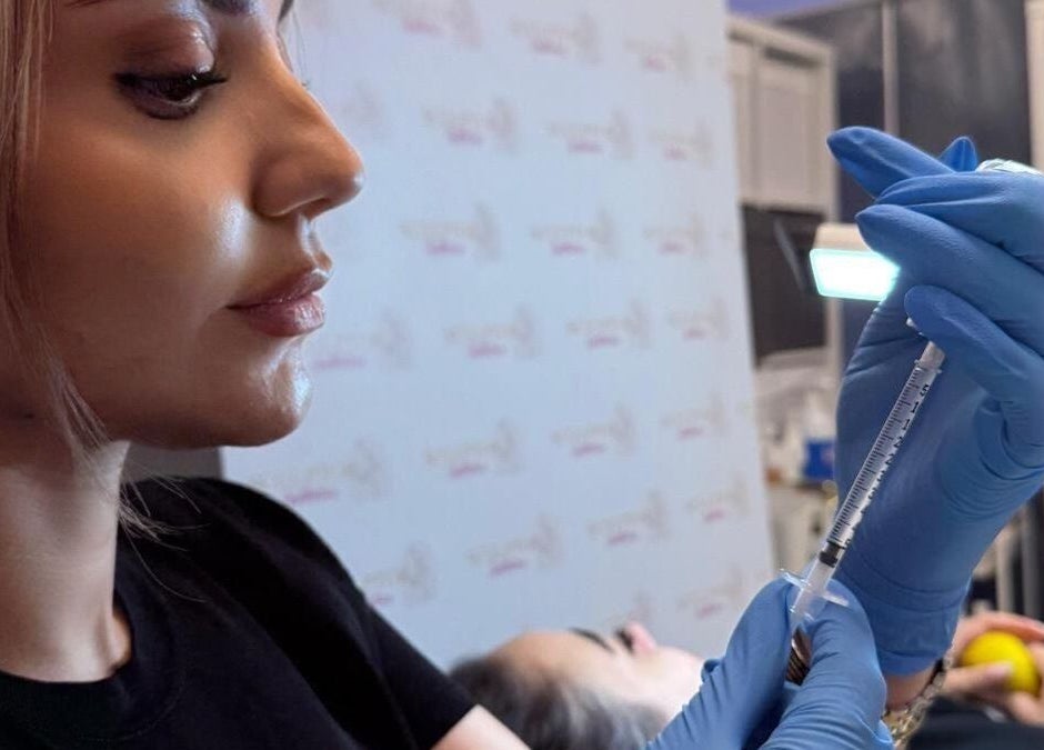 Professional administering treatment at Sculptor Aesthetics, Edgware, England, GB.