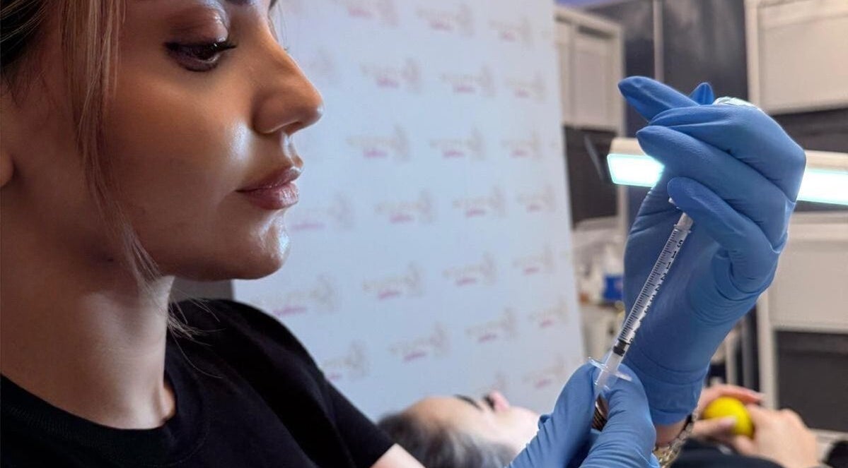 Professional administering treatment at Sculptor Aesthetics, Edgware, England, GB.