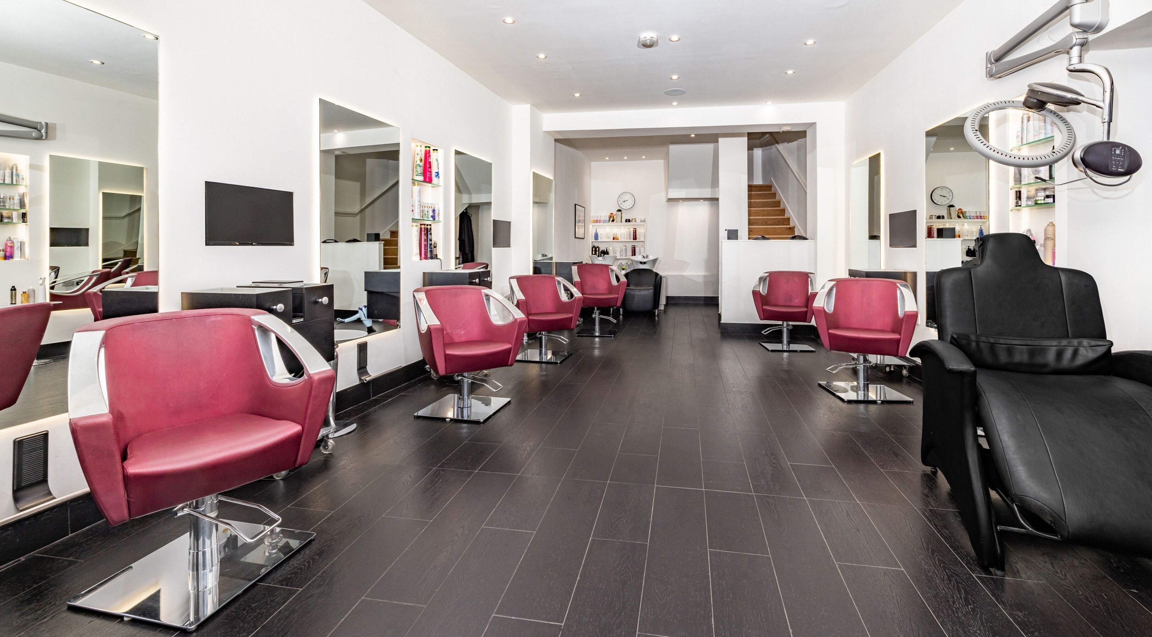 Interior of A&G Hairdressing in Kingston upon Thames, England, showcasing elegant salon chairs and modern decor.