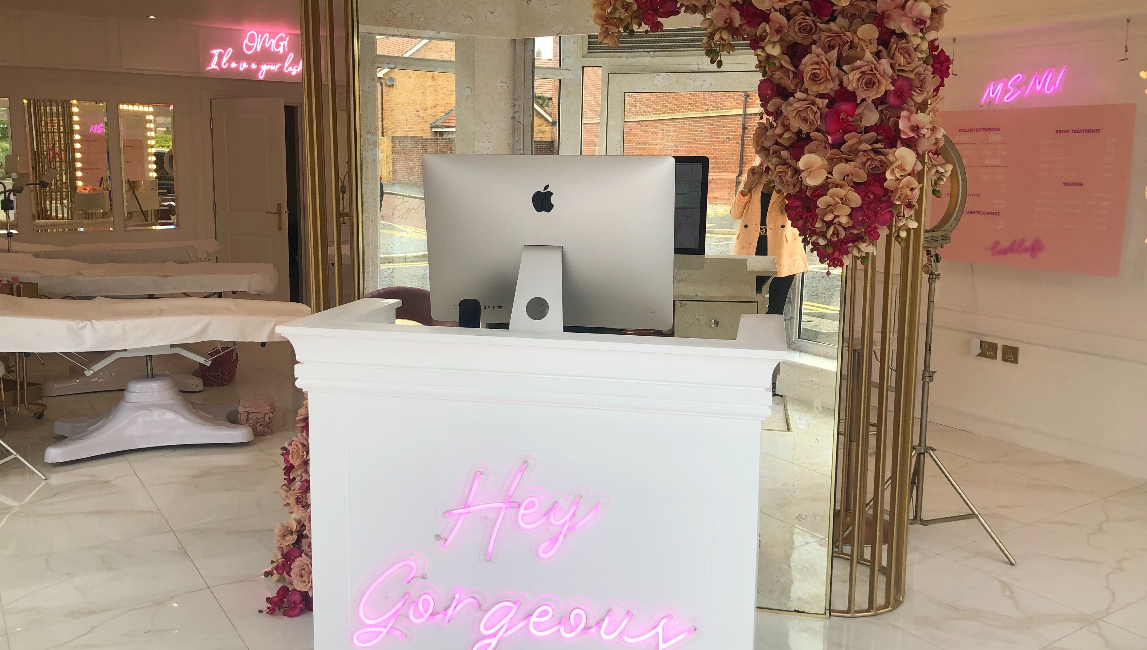 Stylish reception at The Lashloft, Newcastle upon Tyne, England with floral decor and modern design.