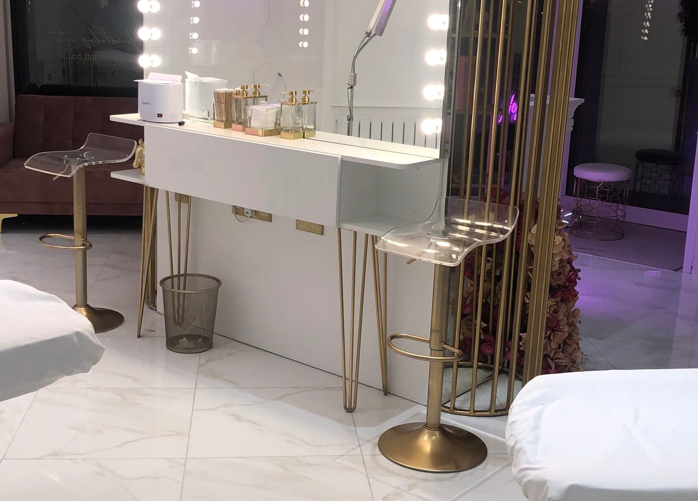 Luxurious interior of The Lashloft in Newcastle upon Tyne with sleek marble floors and stylish gold accents.