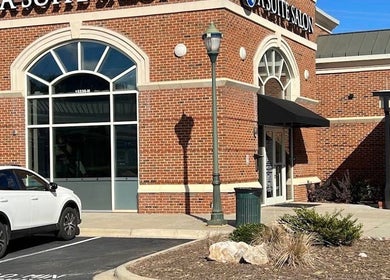 Exterior view of Colored by Megan in Charlotte, North Carolina, US, featuring a stylish red-brick design.