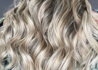Blonde wavy hair styled at Shades, a beauty salon in Dereham, England, GB.