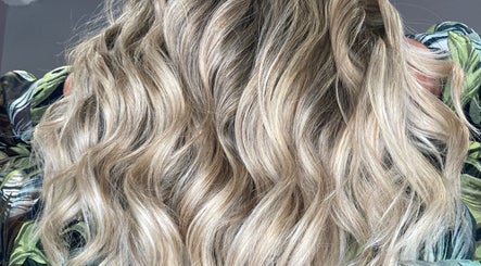 Blonde wavy hair styled at Shades, a beauty salon in Dereham, England, GB.