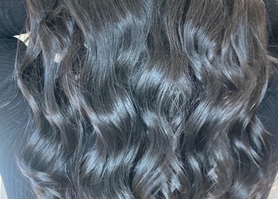 Lustrous wavy black hair styled at Shades salon in Dereham, England, GB.