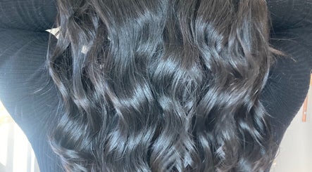 Lustrous wavy black hair styled at Shades salon in Dereham, England, GB.