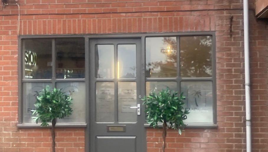 Shades entrance with brick facade in Dereham, England, GB showcasing its welcoming exterior.