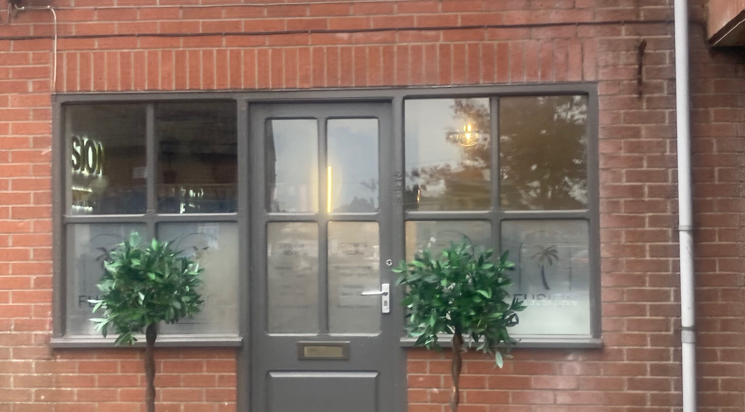 Shades entrance with brick facade in Dereham, England, GB showcasing its welcoming exterior.