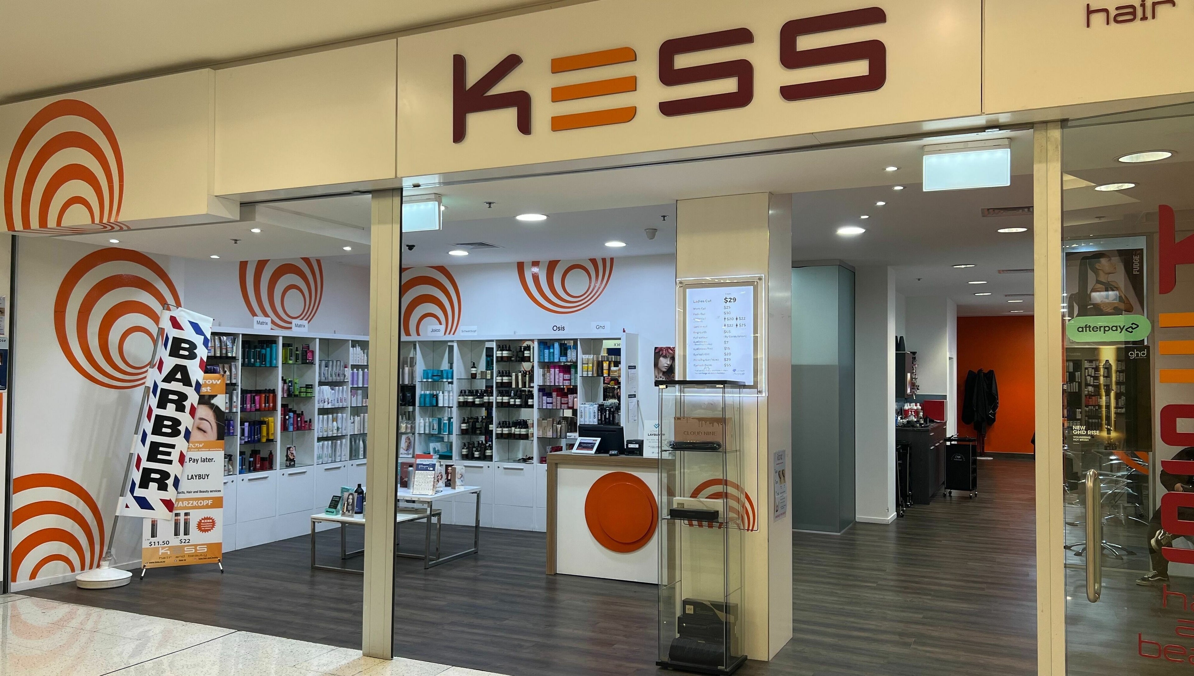 Interior view of Kess Hair & Beauty St. Lukes, Auckland, showcasing vibrant decor and modern styling products.
