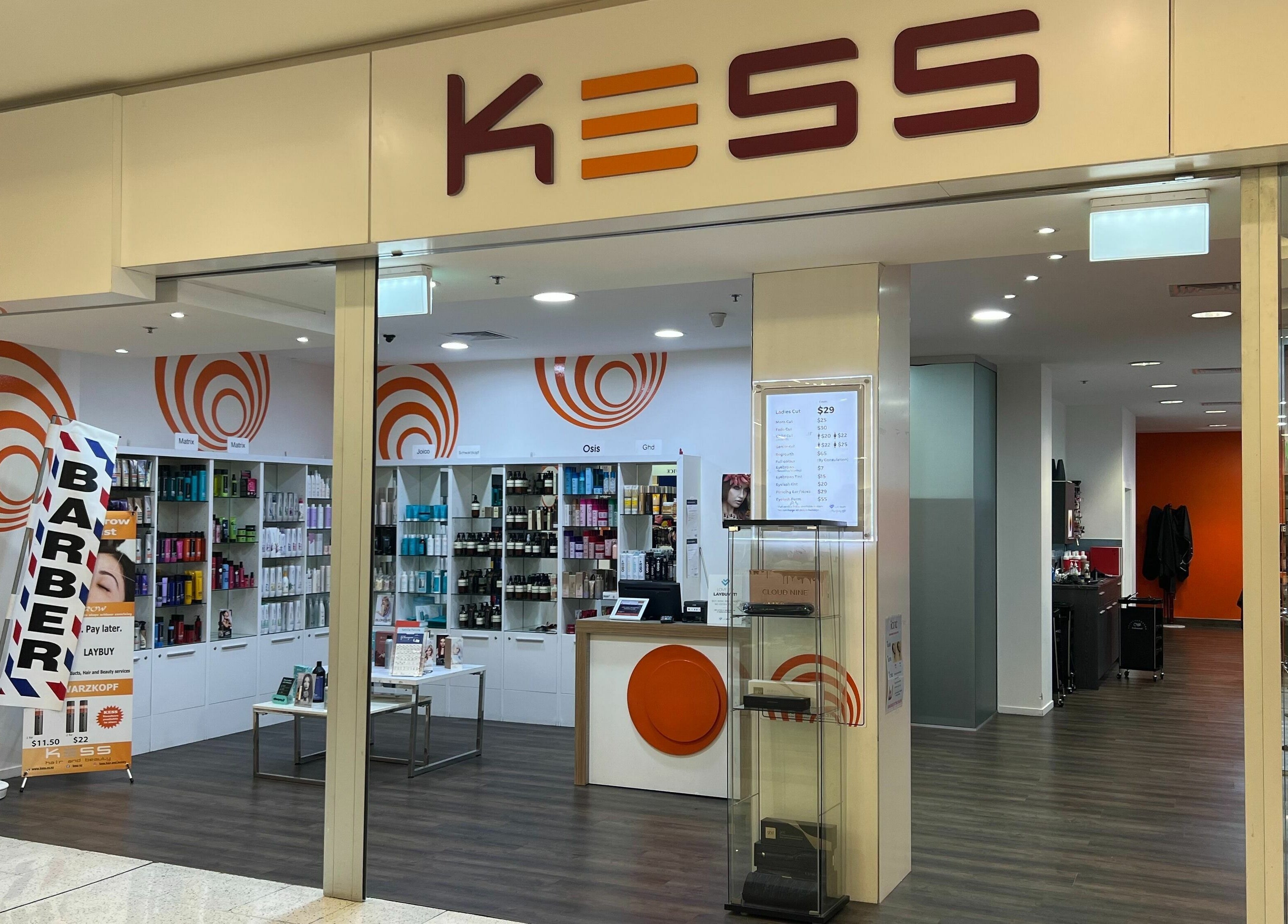 Interior view of Kess Hair & Beauty St. Lukes, Auckland, showcasing vibrant decor and modern styling products.