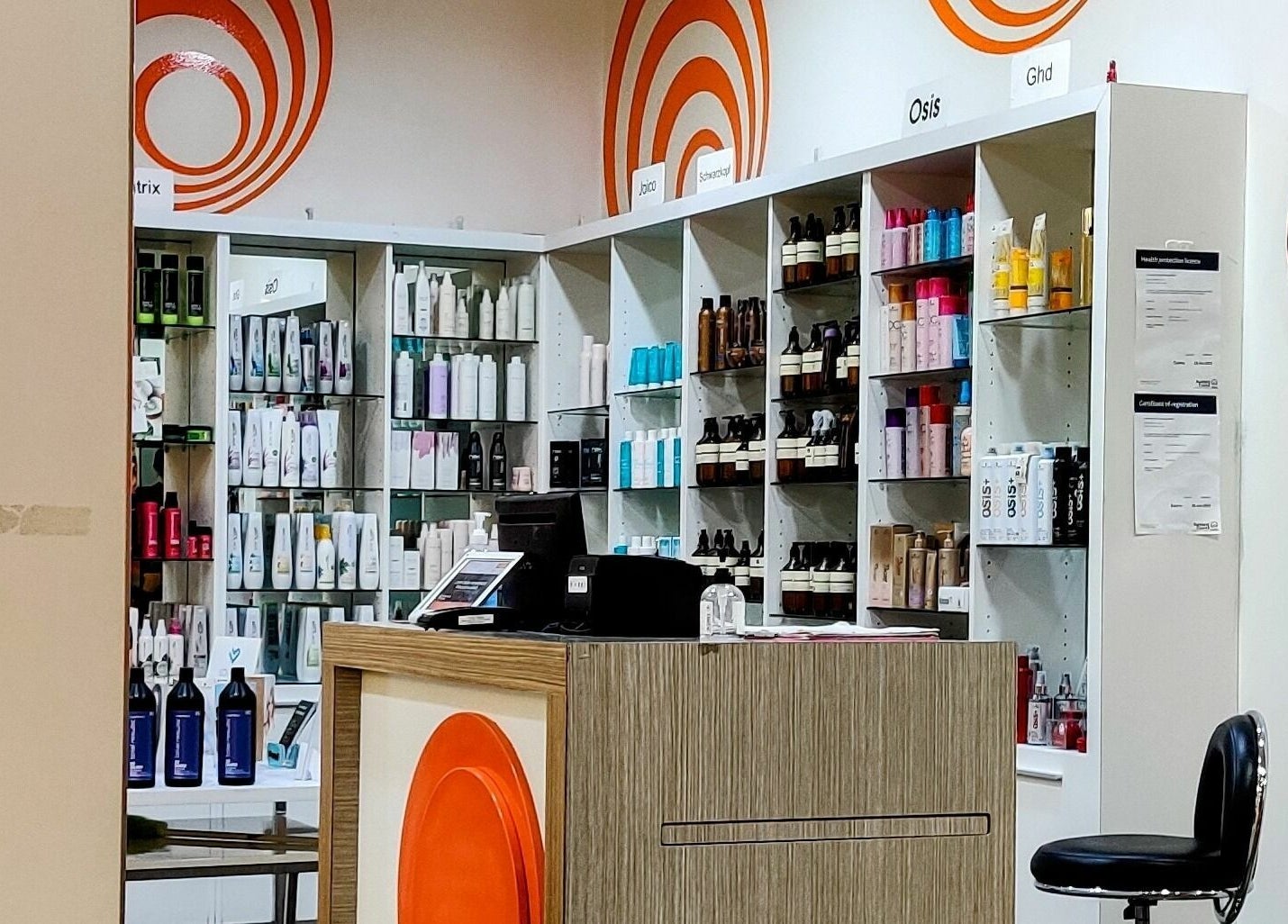 Stylish interior of Kess Hair & Beauty St. Lukes, Auckland. Shelves with diverse hair and beauty products.