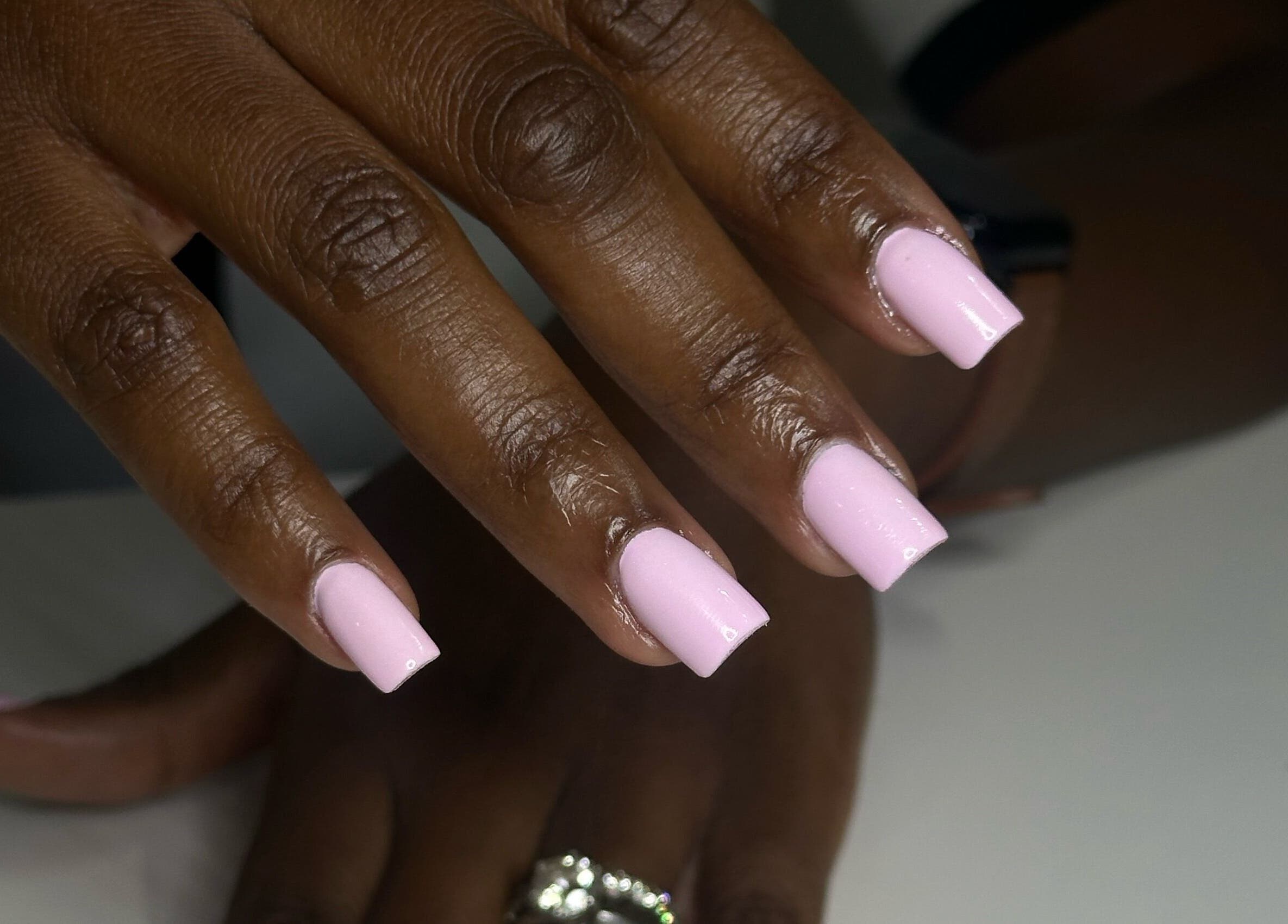 Close-up of manicured pink nails at Day and Night Beauty, Kingston, St. Andrew Parish, JM.