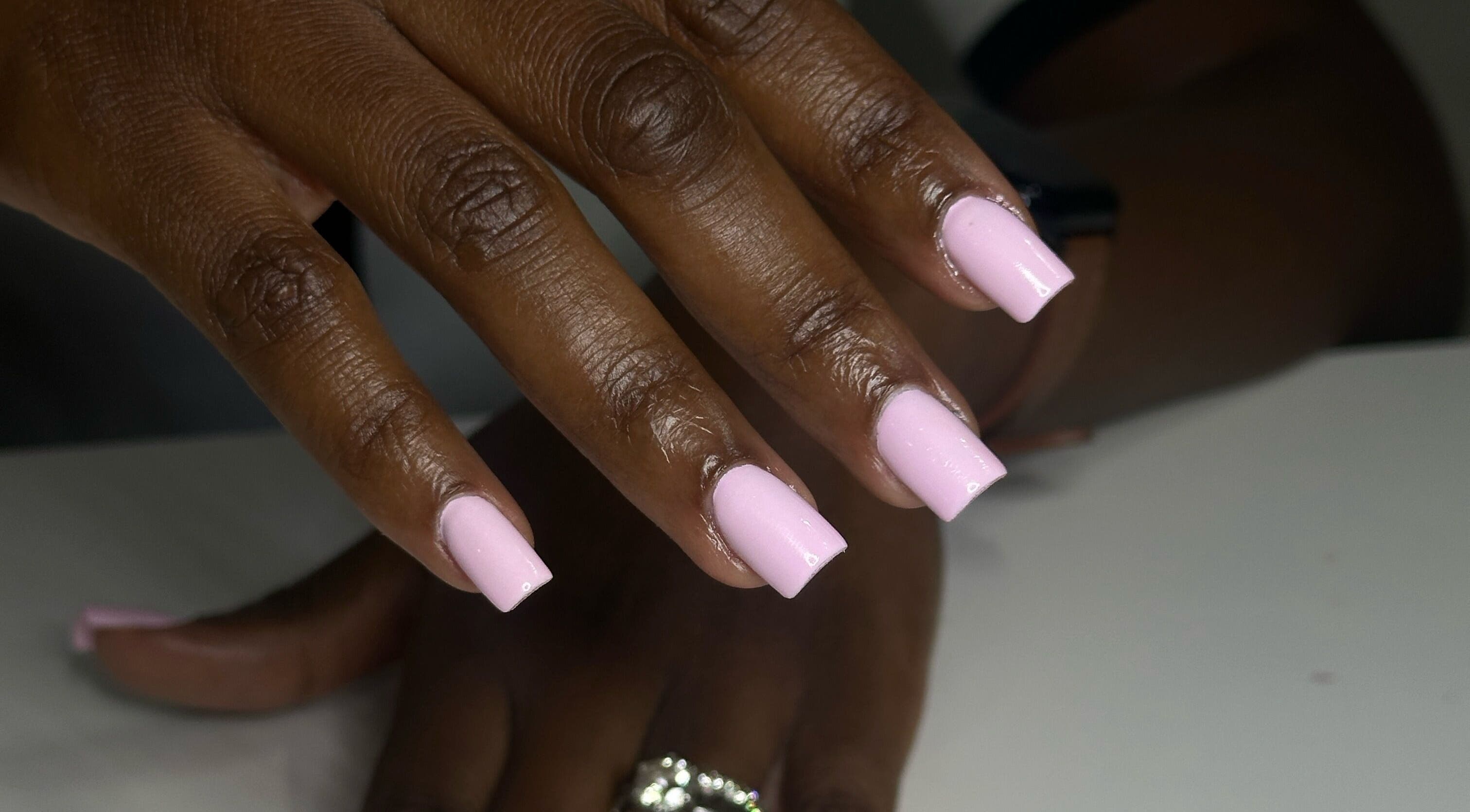 Close-up of manicured pink nails at Day and Night Beauty, Kingston, St. Andrew Parish, JM.