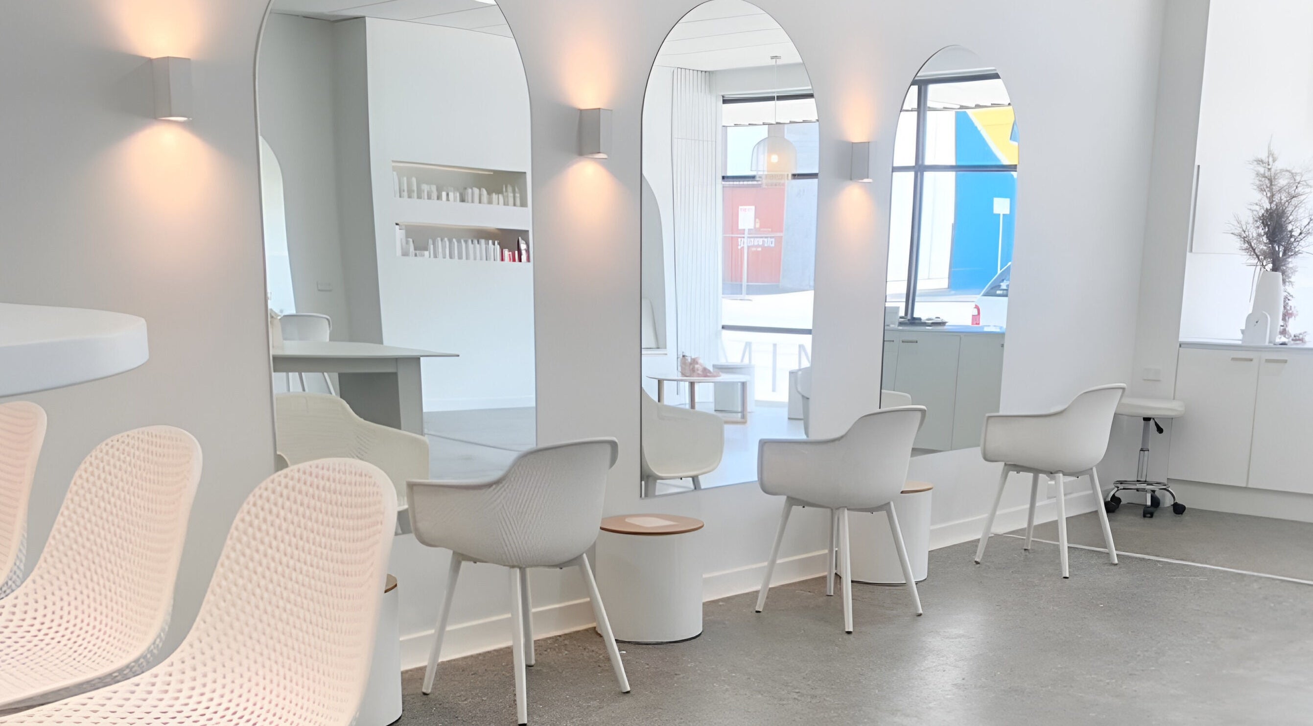 Interior of Minx Blowdry Bar in Ballarat Central, Victoria, AU, featuring stylish white chairs and mirrors.