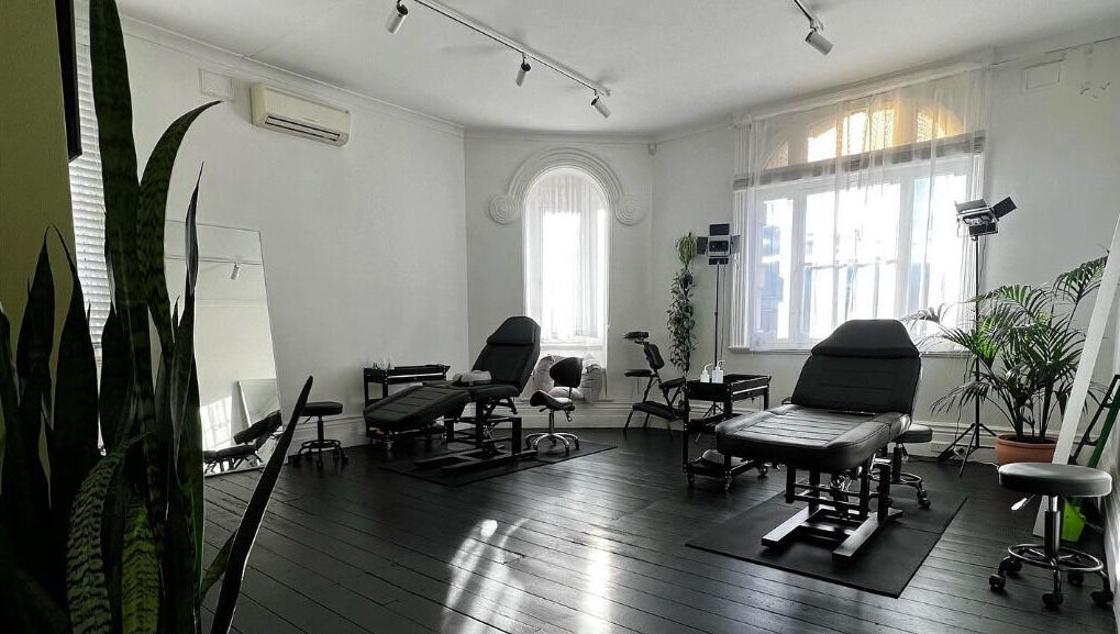 Inkd SMP's sleek wellness studio with black chairs in Melbourne, Victoria, AU.