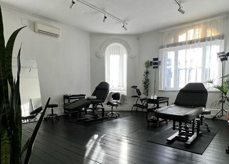 Inkd SMP's sleek wellness studio with black chairs in Melbourne, Victoria, AU.