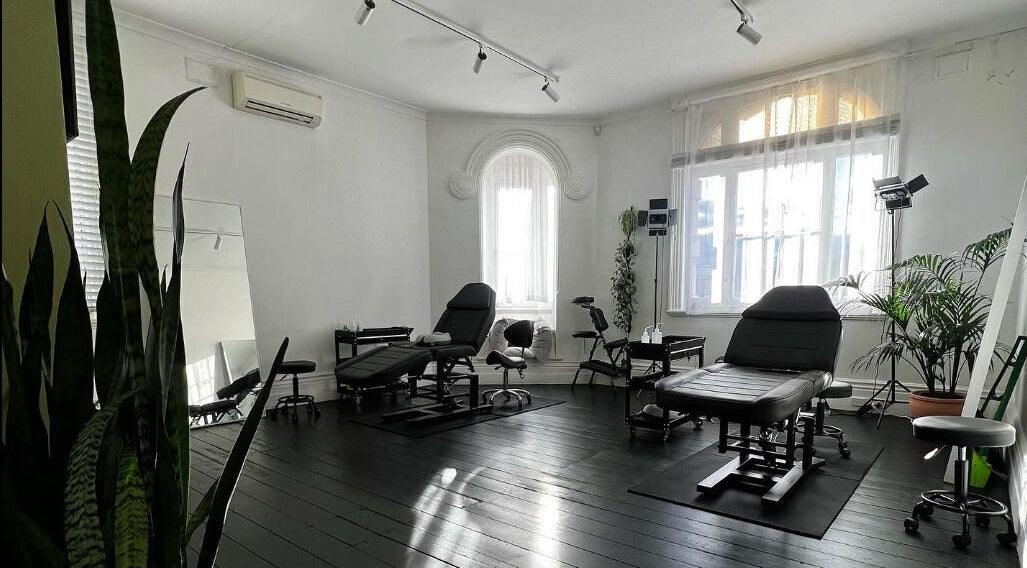 Inkd SMP's sleek wellness studio with black chairs in Melbourne, Victoria, AU.