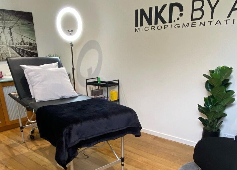 Modern treatment room at Inkd SMP in Melbourne, Victoria, AU with a comfortable bed and stylish decor.