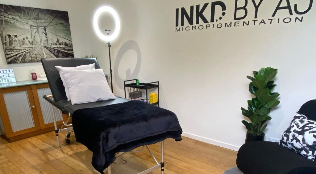 Modern treatment room at Inkd SMP in Melbourne, Victoria, AU with a comfortable bed and stylish decor.