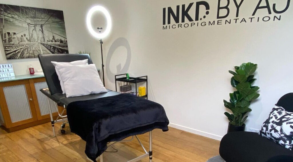 Modern treatment room at Inkd SMP in Melbourne, Victoria, AU with a comfortable bed and stylish decor.