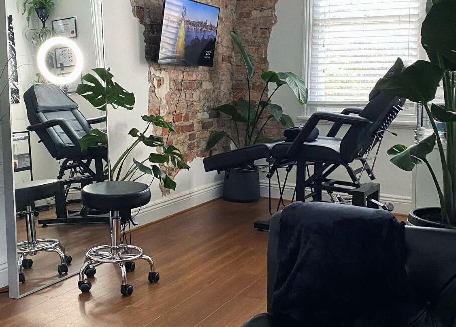 Stylish interior of Inkd SMP in Melbourne, Victoria, AU, featuring a modern chair and ambient greenery.