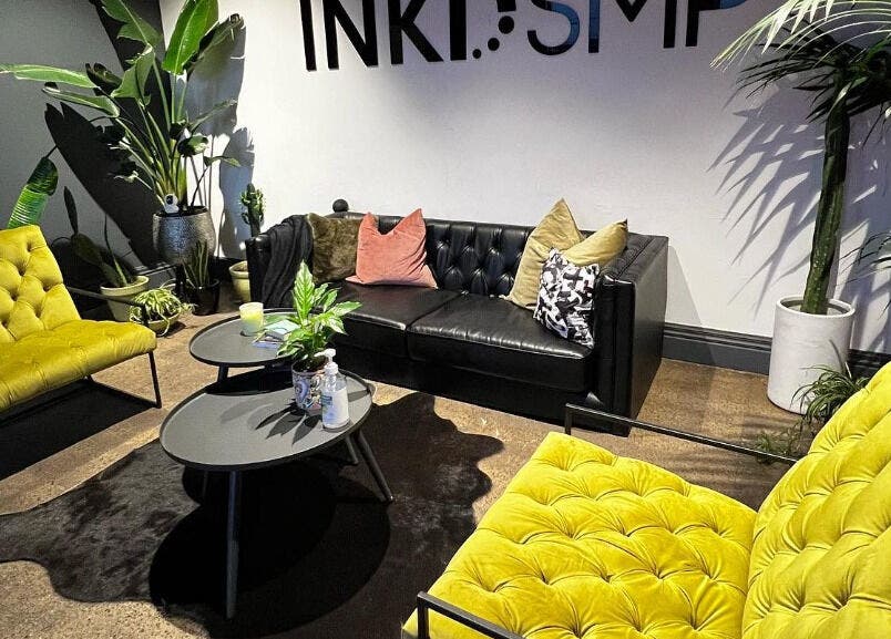 Stylish waiting area at Inkd SMP, Melbourne, Victoria, AU with lush green plants and modern seating.