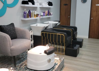 Luxurious salon interior at Beautique by Genesis, Mayagüez, PR with modern seating and hair wash stations.