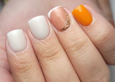 Stylish manicure with orange and gold accents at Beautique by Genesis, Mayagüez, Mayagüez, PR.