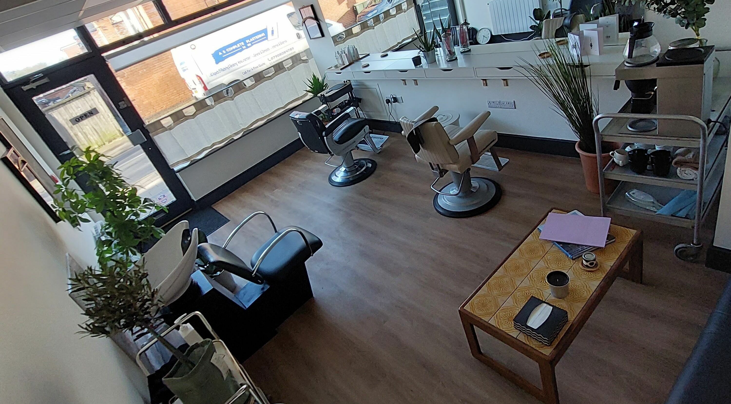 Modern salon interior at Four Four Hair, Nottingham, England, GB featuring sleek chairs and stylish decor.