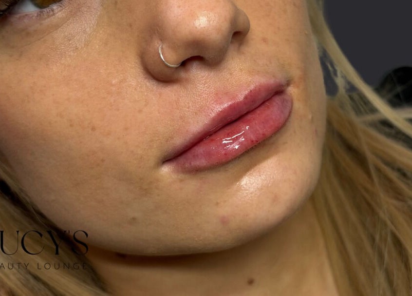 Close-up of glossy lips and nose ring at Lucys Beauty Lounge in Addlestone, England, GB.