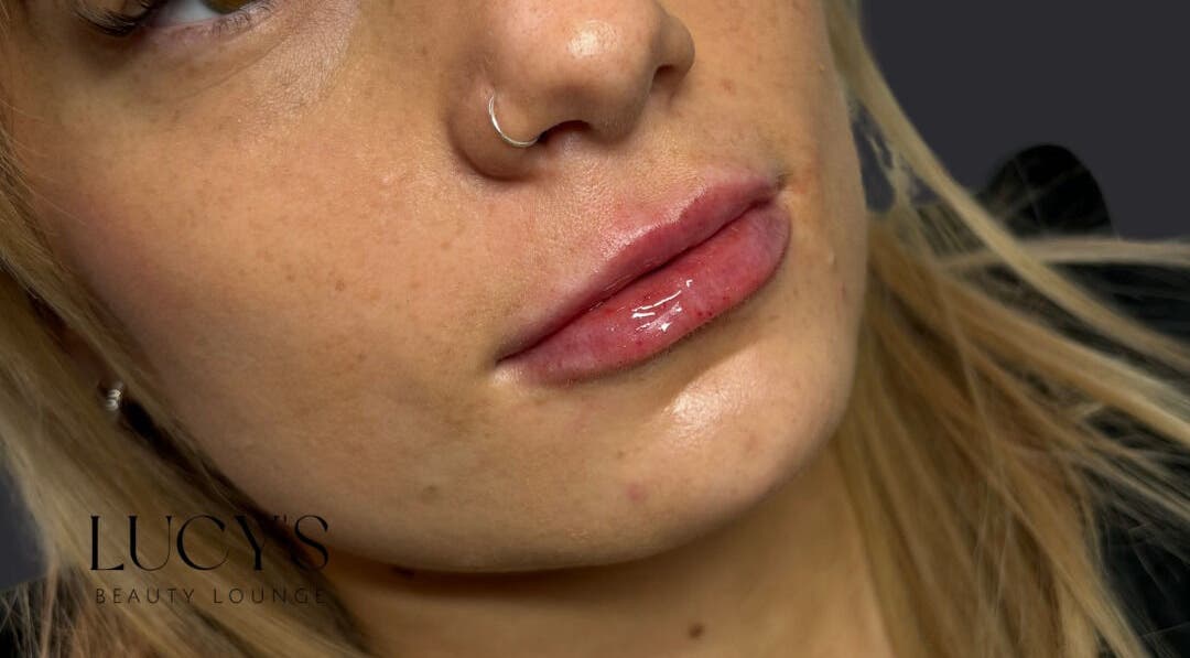 Close-up of glossy lips and nose ring at Lucys Beauty Lounge in Addlestone, England, GB.