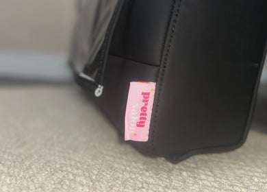 Close-up of 'Pretty' tag on a stylish bag at The Pretty Parlour, Gloucester, England, GB.