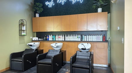Modern wash station at Fantastic Sams in New Lenox, Illinois, US with sleek chairs and hair products.