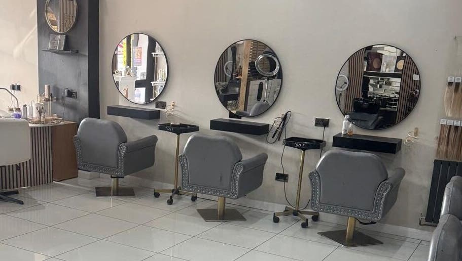 Elegant salon interior at The Mix Up, Cannock, England, GB with stylish mirrors and plush chairs.