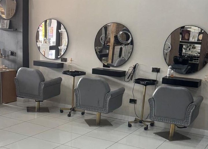 Elegant salon interior at The Mix Up, Cannock, England, GB with stylish mirrors and plush chairs.