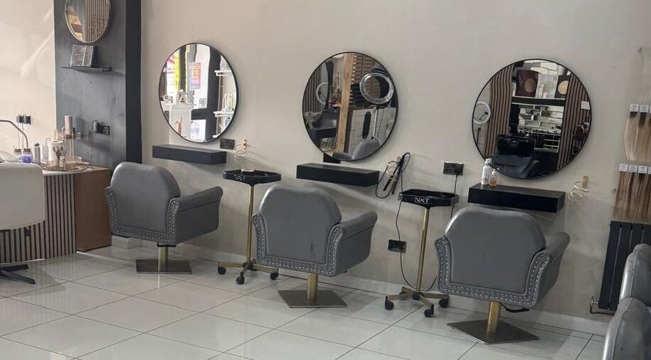 Elegant salon interior at The Mix Up, Cannock, England, GB with stylish mirrors and plush chairs.