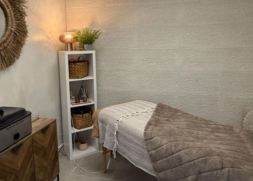 Relaxing treatment room at The Mix Up, Cannock, England, GB with warm tones and a plush massage table.