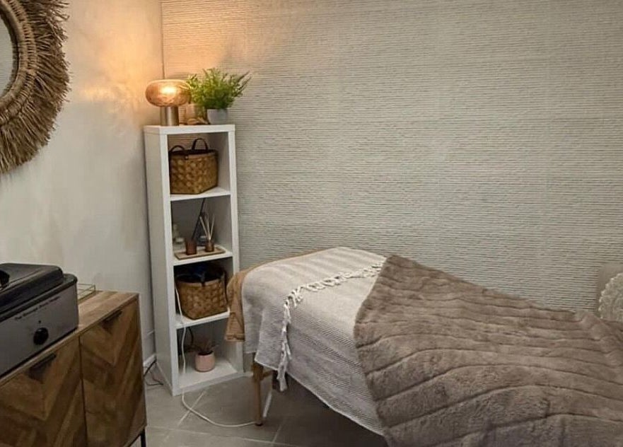 Relaxing treatment room at The Mix Up, Cannock, England, GB with warm tones and a plush massage table.