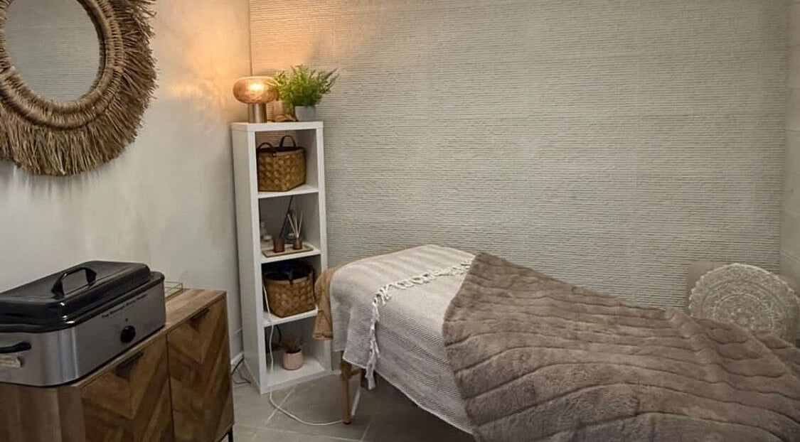 Relaxing treatment room at The Mix Up, Cannock, England, GB with warm tones and a plush massage table.