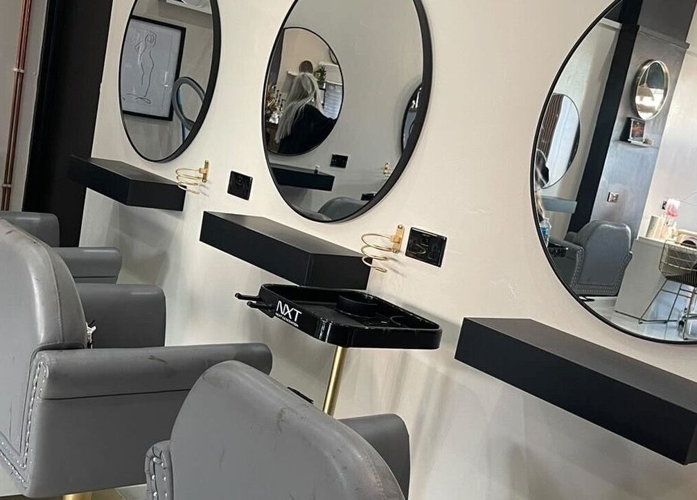 Luxury styling stations at The Mix Up, Cannock, England, GB with chic mirrors and modern chairs.