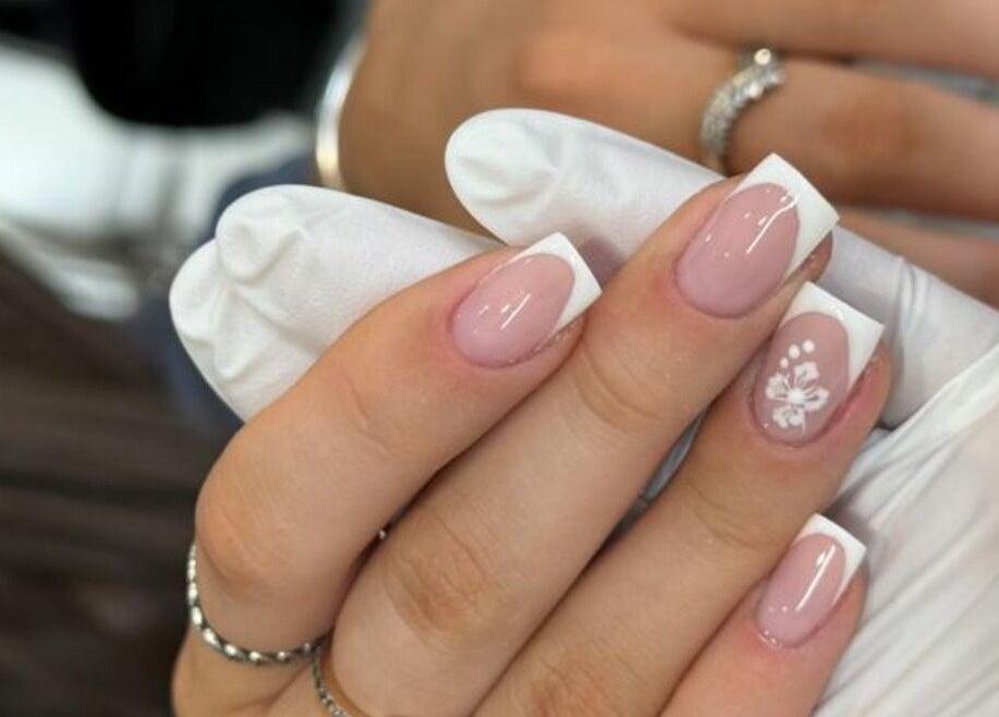 Elegant French manicure with floral design at The Mix Up, Cannock, England, GB.