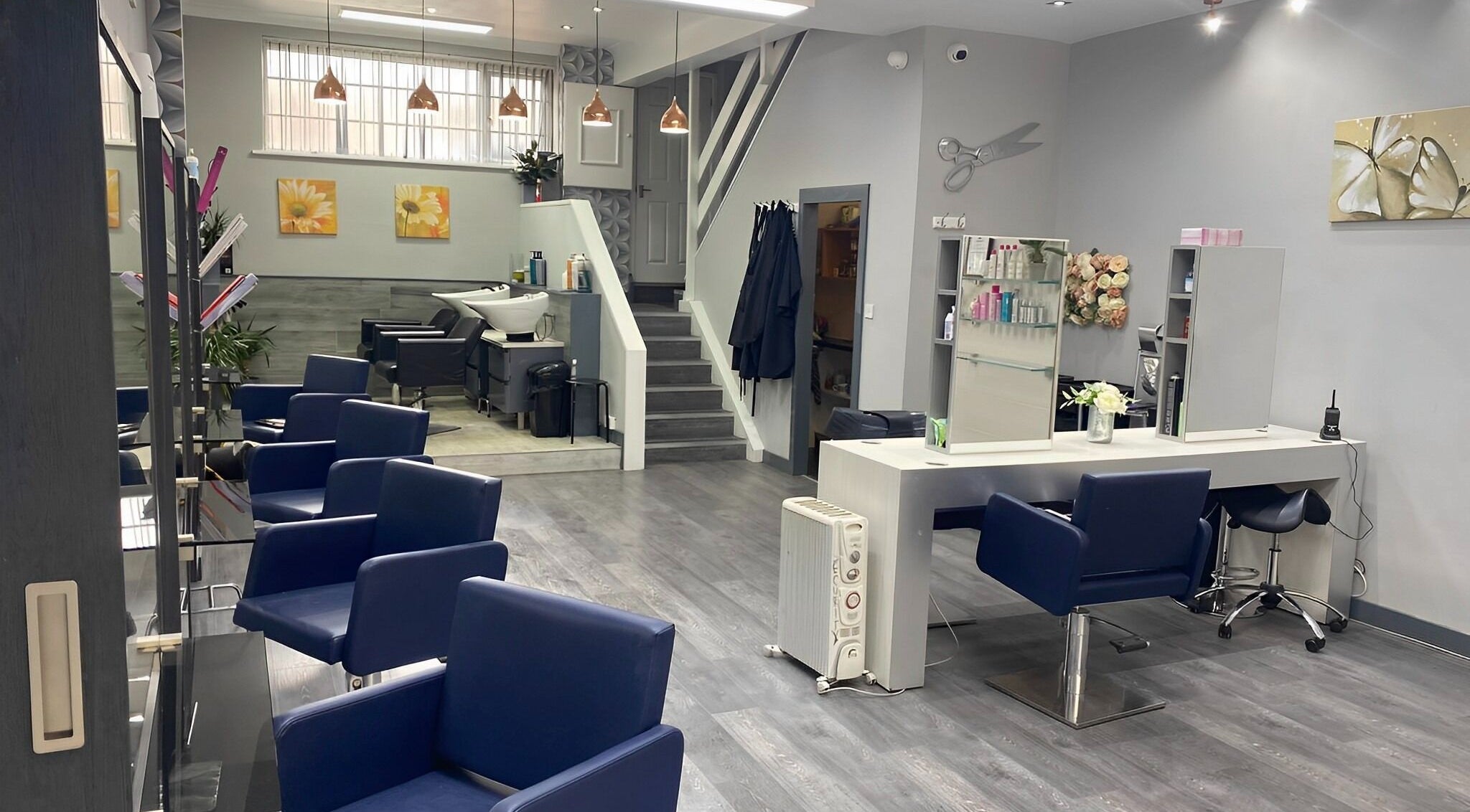Enigma Hair and Beauty Salon in Halesowen, England, GB features chic blue chairs and modern decor.