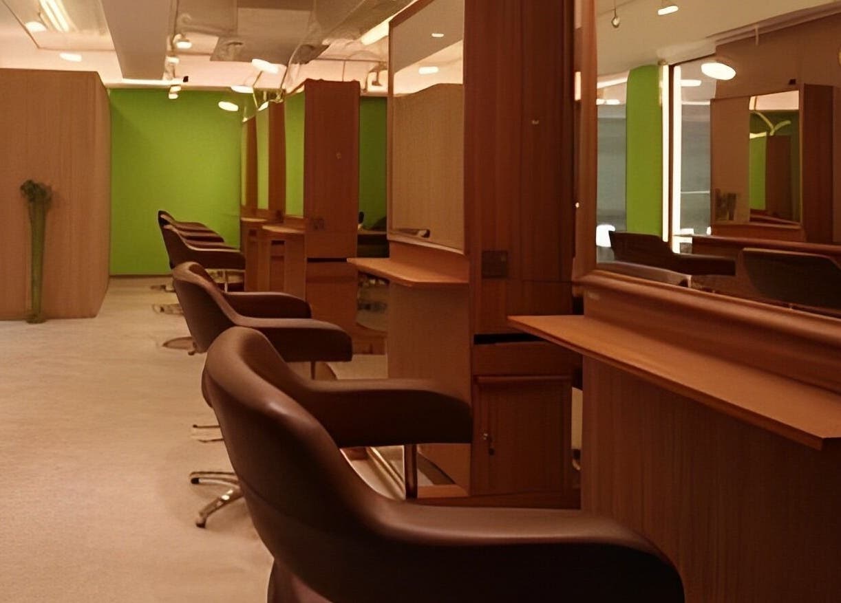 Modern salon interior at Causeway Bay Branch, Hong Kong Island, HK with sleek brown chairs and green accents.