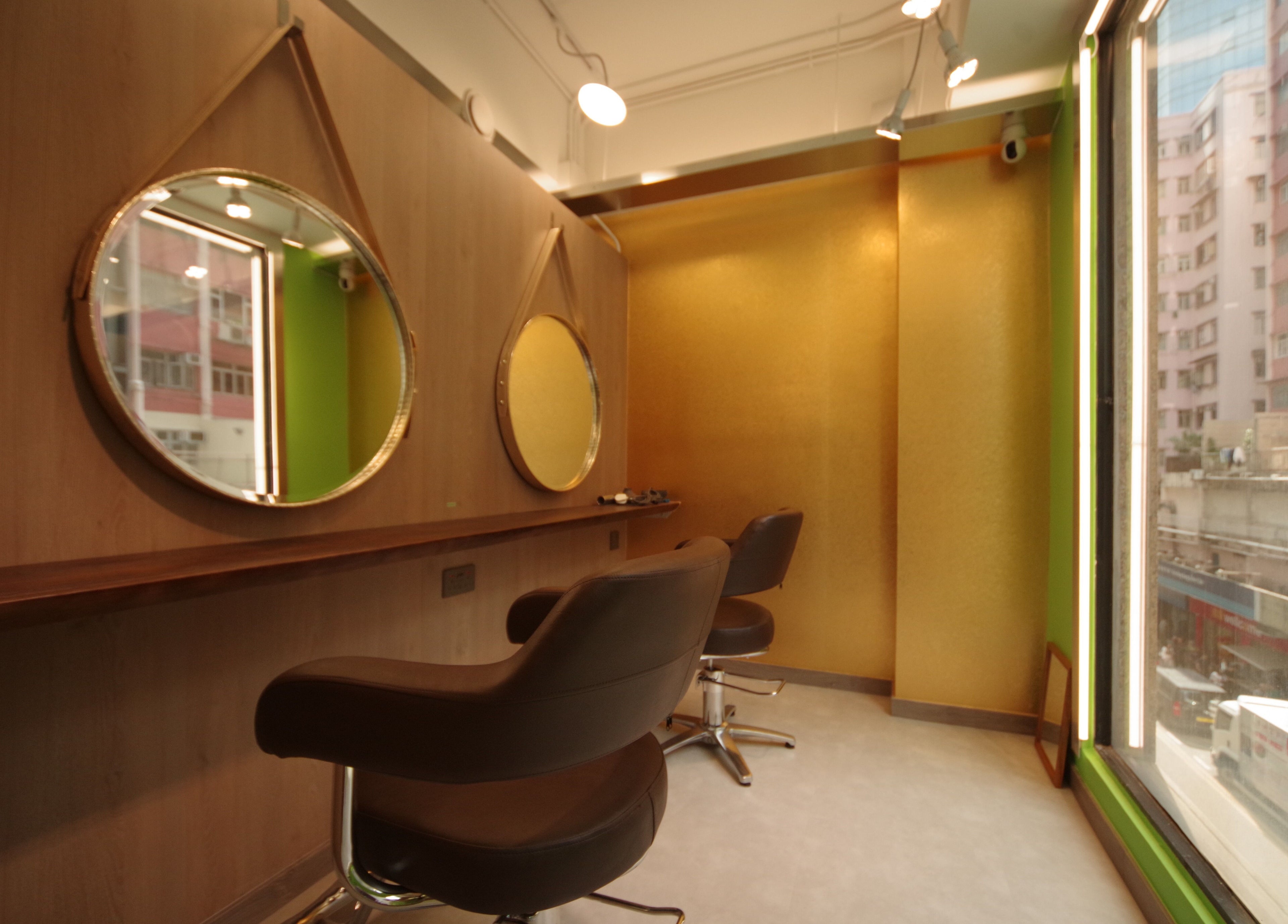 Modern salon interior at Causeway Bay Branch, Hong Kong Island, HK, featuring chic mirrors and elegant chairs.
