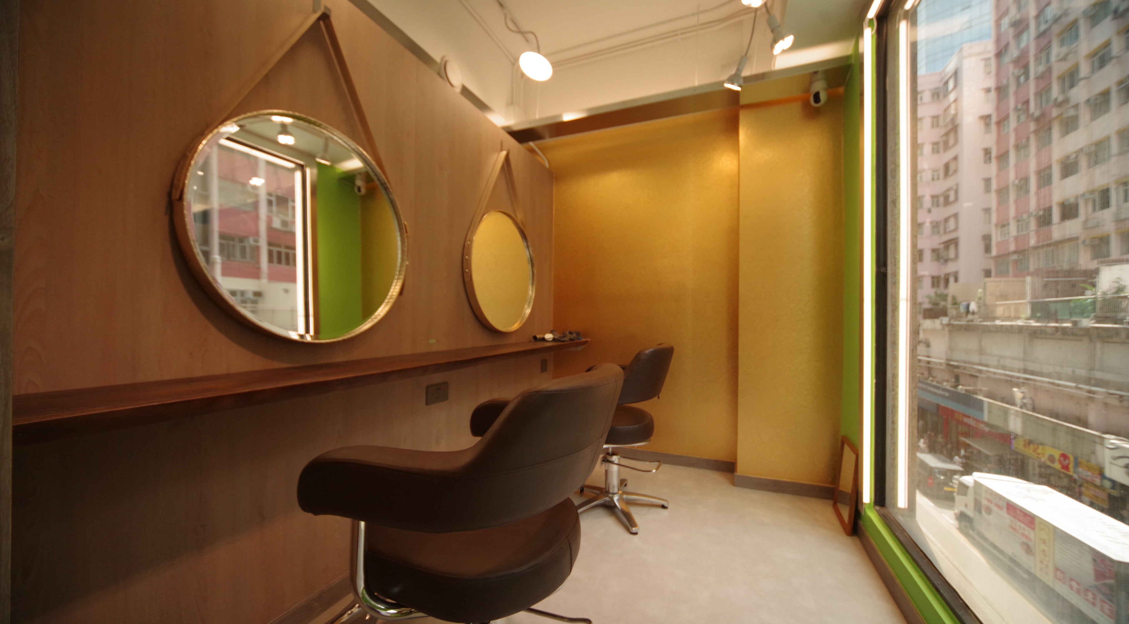 Modern salon interior at Causeway Bay Branch, Hong Kong Island, HK, featuring chic mirrors and elegant chairs.