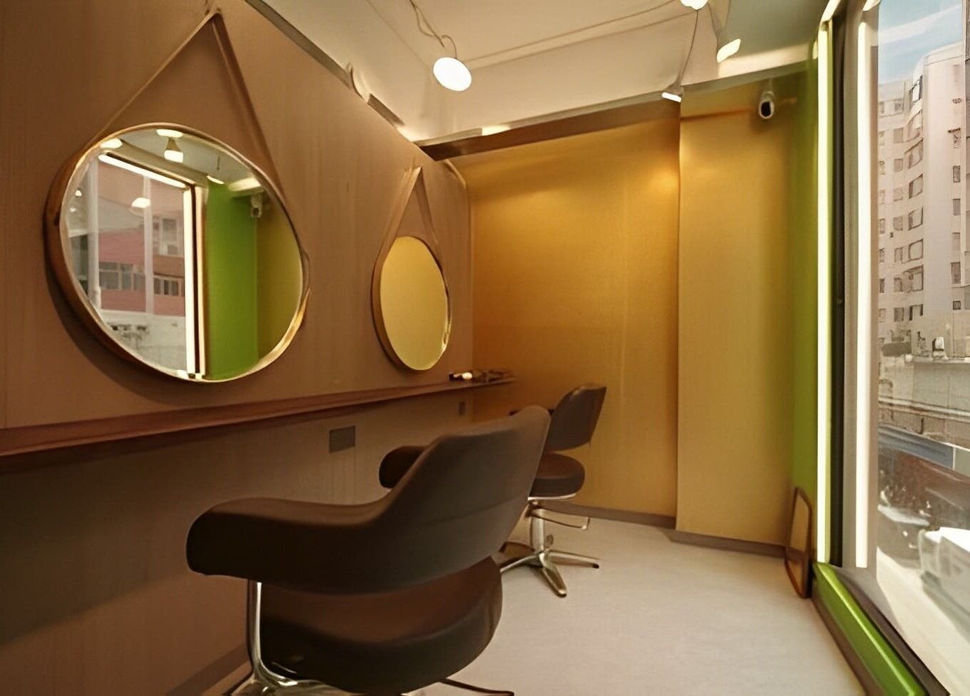 Chic salon interior at Causeway Bay Branch, Hong Kong Island. Features modern styling chairs and large mirrors.